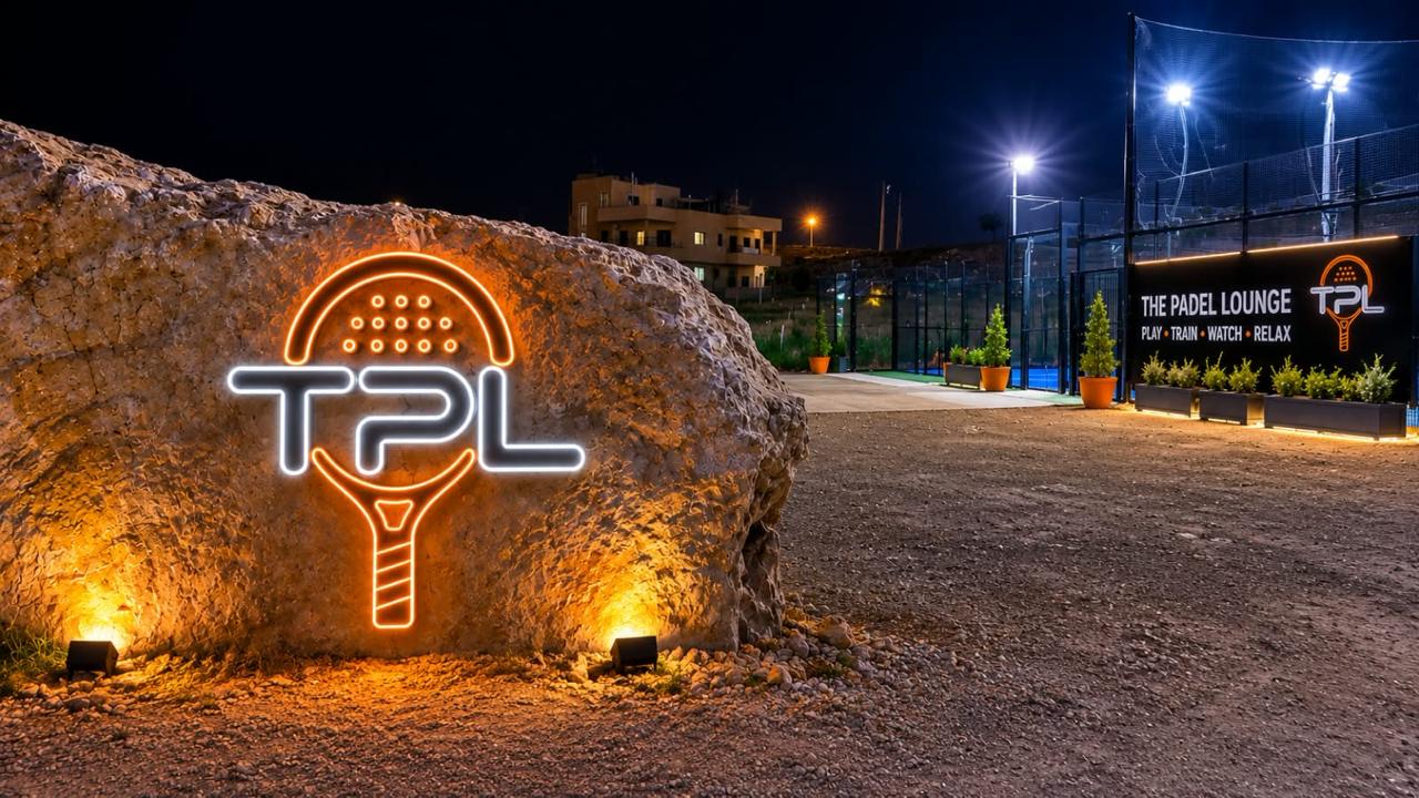floodlit entrance with neon tpl sign